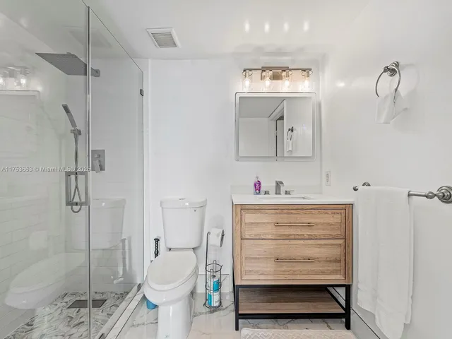 a bathroom with a toilet a sink and a shower