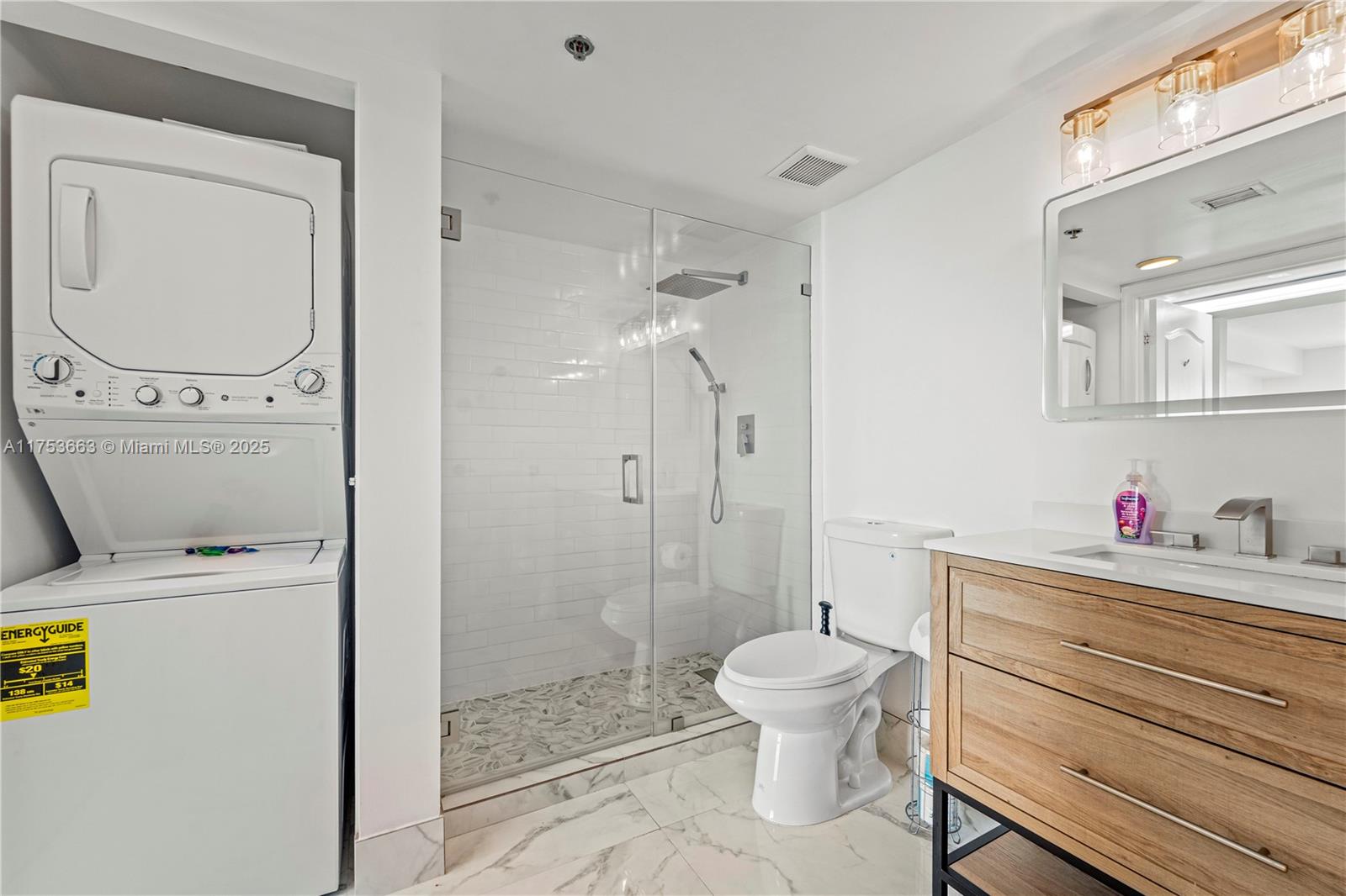 1200 Brickell Bay Drive, Unit 4019 Miami, FL 33131 - Photo 24 of 32 a bathroom with a toilet a sink and a shower