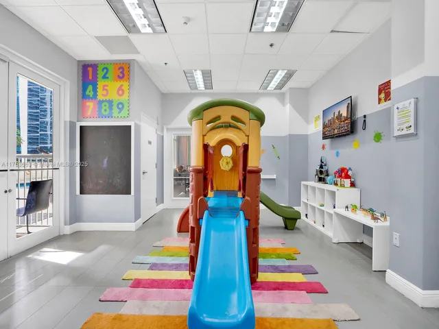 a living room with lots of furniture and a large window