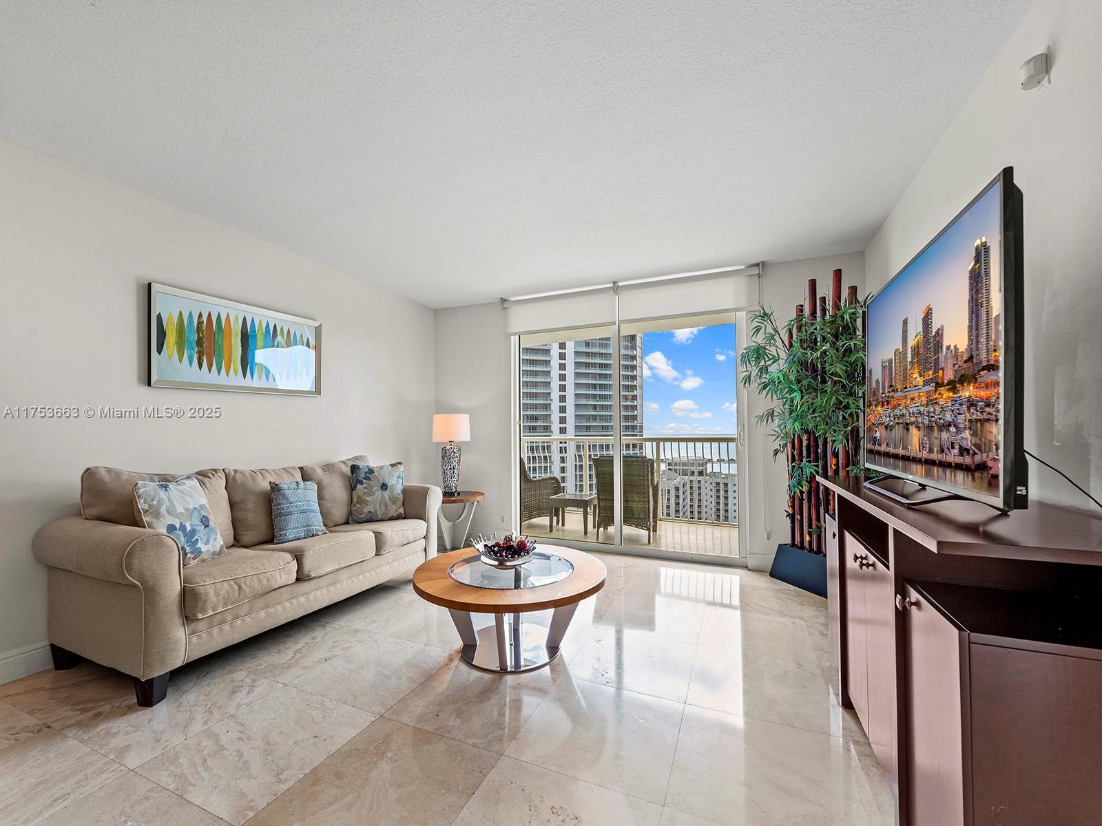 1200 Brickell Bay Drive, Unit 4019 Miami, FL 33131 - Photo 7 of 32 a living room with furniture a table and a large window