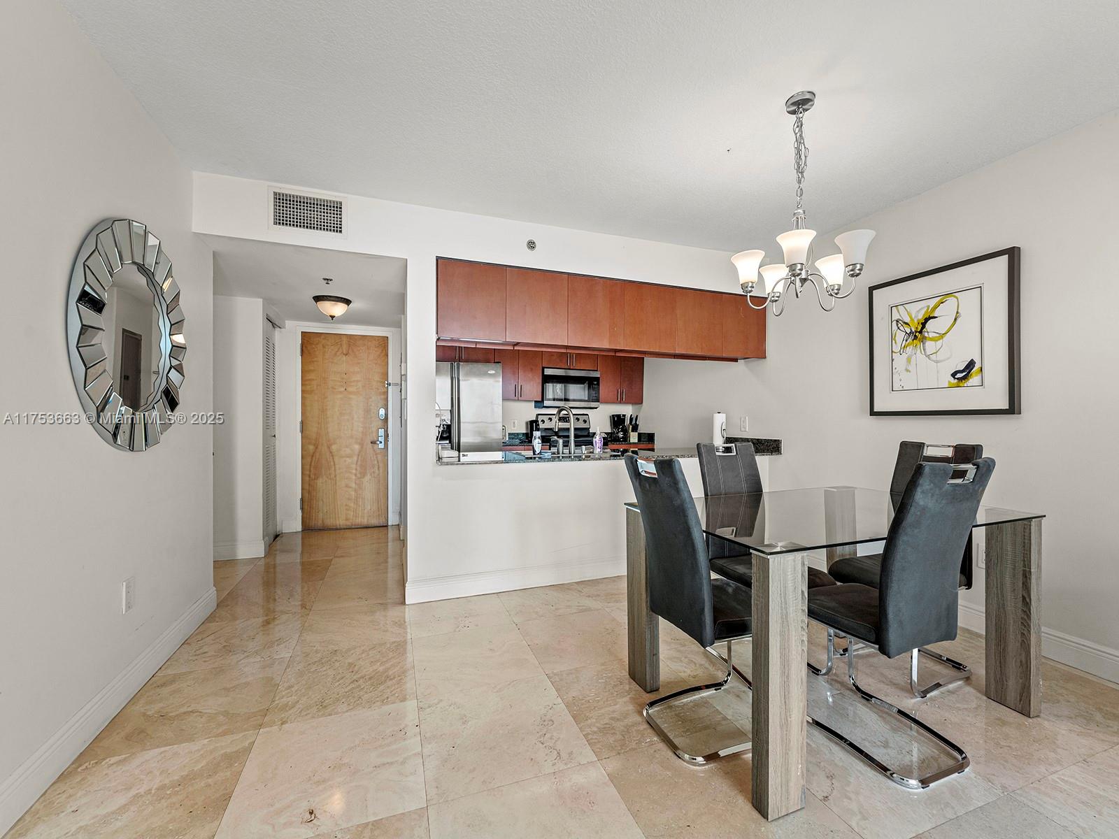 1200 Brickell Bay Drive, Unit 4019 Miami, FL 33131 - Photo 9 of 32 a view of a dining room with furniture and chandelier