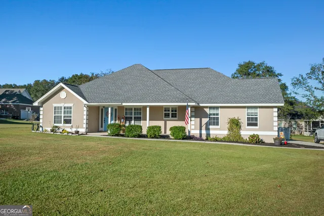 a front view of a house with a garden