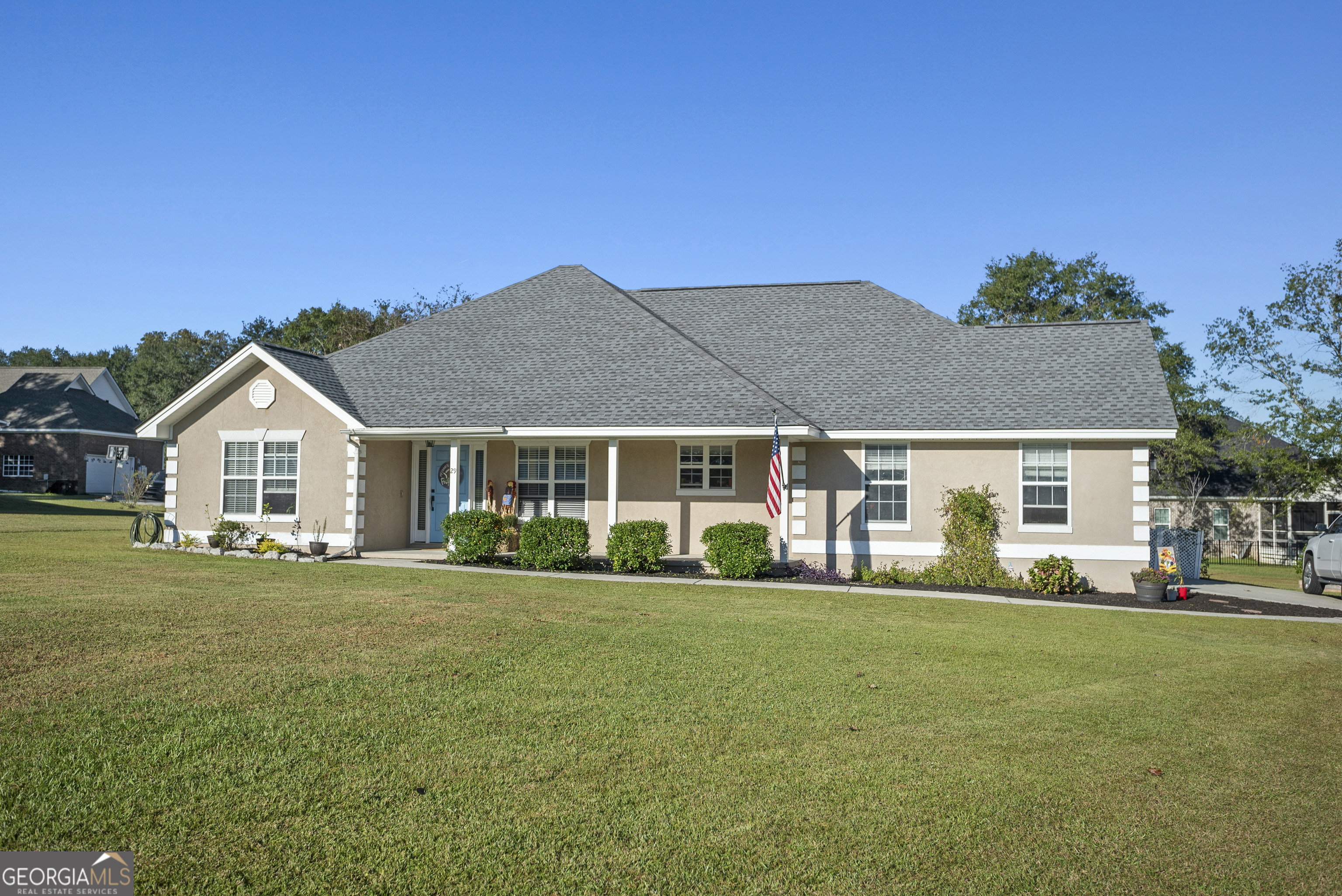 a front view of a house with a garden