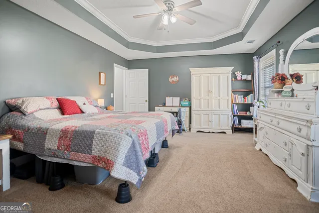 a spacious bedroom with a bed and closet