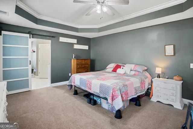 a spacious bedroom with a bed and a chandelier