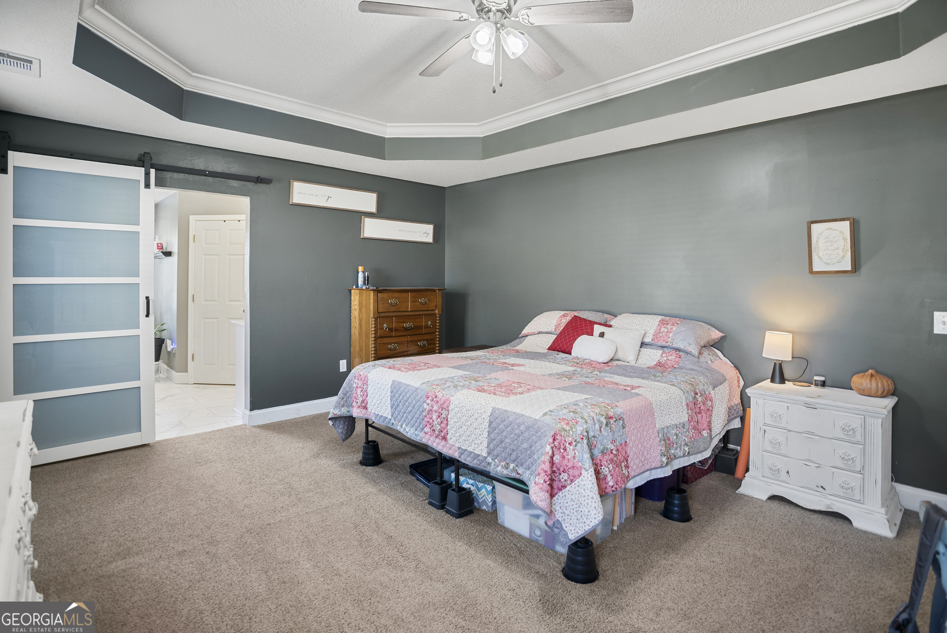 29 Sterling Court Ellabell, GA 31308 - Photo 20 of 40 a spacious bedroom with a bed and a chandelier