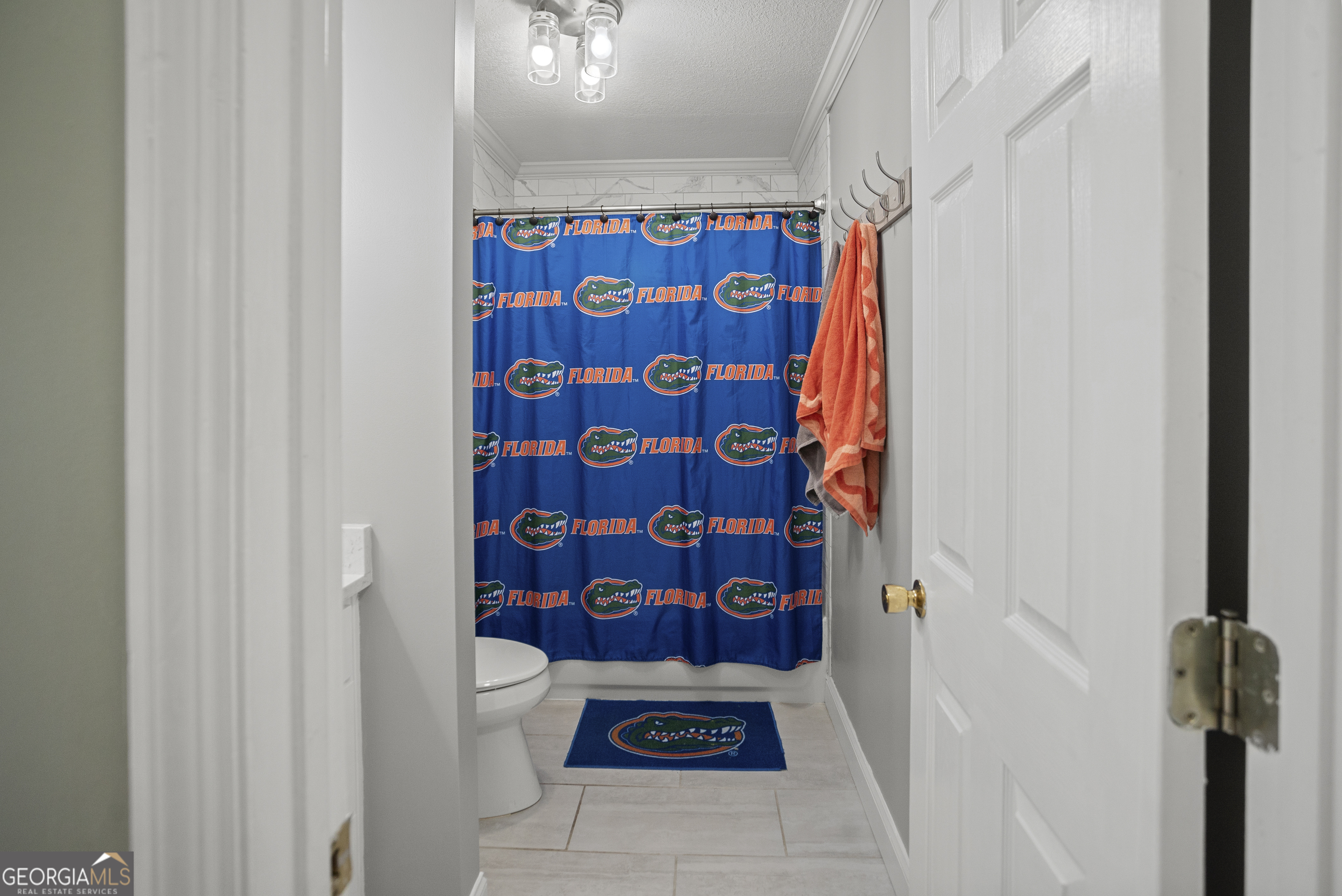 29 Sterling Court Ellabell, GA 31308 - Photo 25 of 40 a bathroom with a shower curtain and a toilet