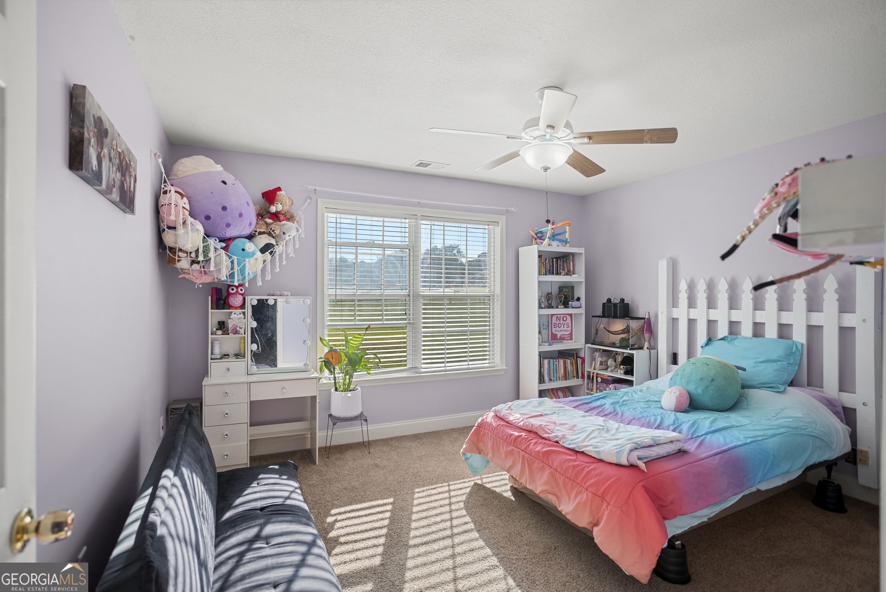 29 Sterling Court Ellabell, GA 31308 - Photo 27 of 40 a bedroom with a bed and a chandelier