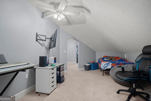 a utility room with furniture and a ceiling fan