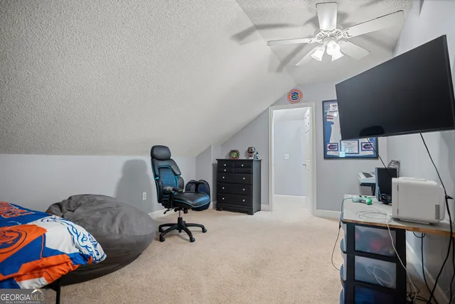a view of a workspace with furniture and a flat screen tv