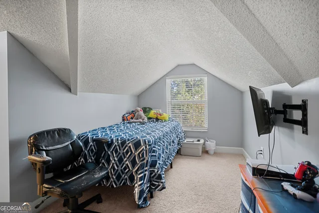 a bedroom with a bed closet and a window