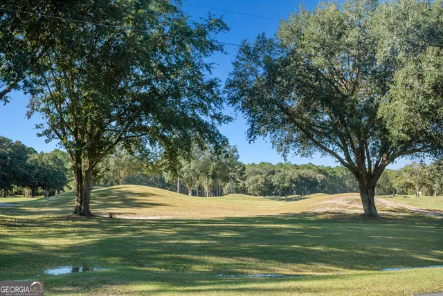 a stone house with trees in front of it