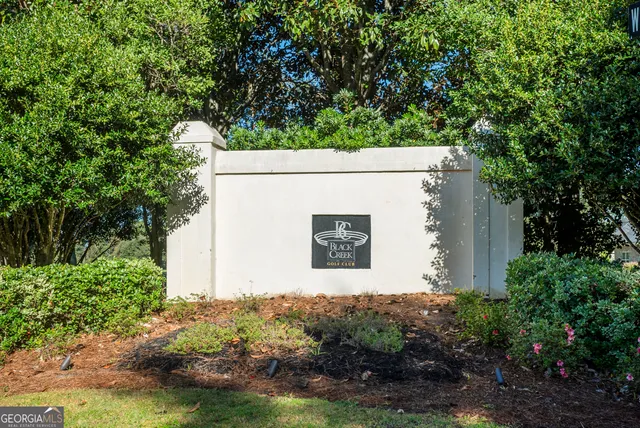 a view of a grassy field with trees