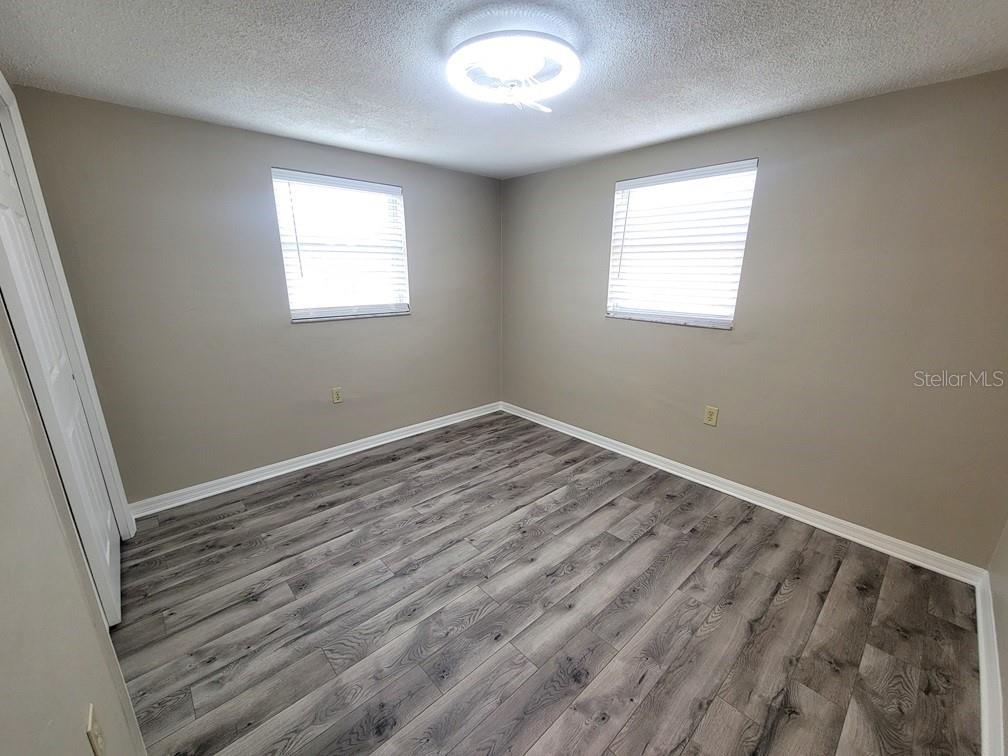 7335 Castanea Drive Port Richey, FL 34668 - Photo 14 of 20 a view of room with window and hardwood floor