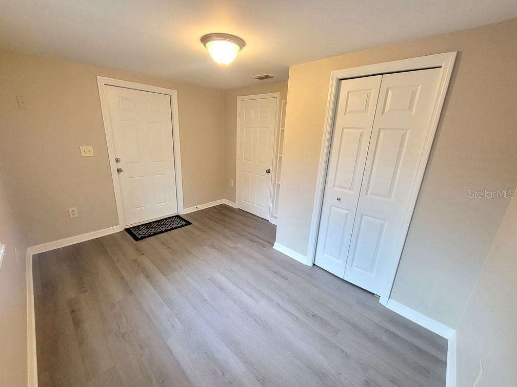 7335 Castanea Drive Port Richey, FL 34668 - Photo 17 of 20 a view of an empty room with wooden floor