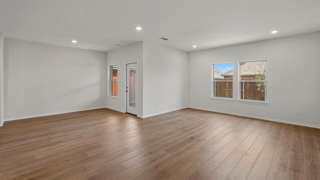 1627 Mantle Road Crandall, TX 75114 - Photo 11 of 40 Expansive room featuring wood-finish flooring, recessed lighting, and multiple windows for abundant natural light