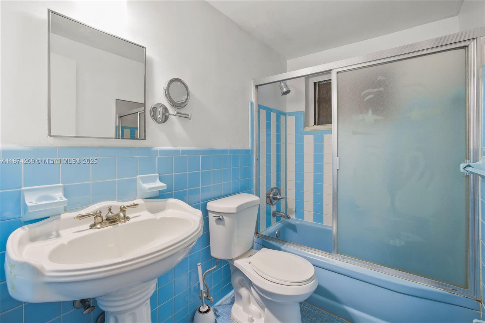 641 Española Way, Unit 3 Miami Beach, FL 33139 - Photo 13 of 23 a bathroom with a sink a toilet and a mirror