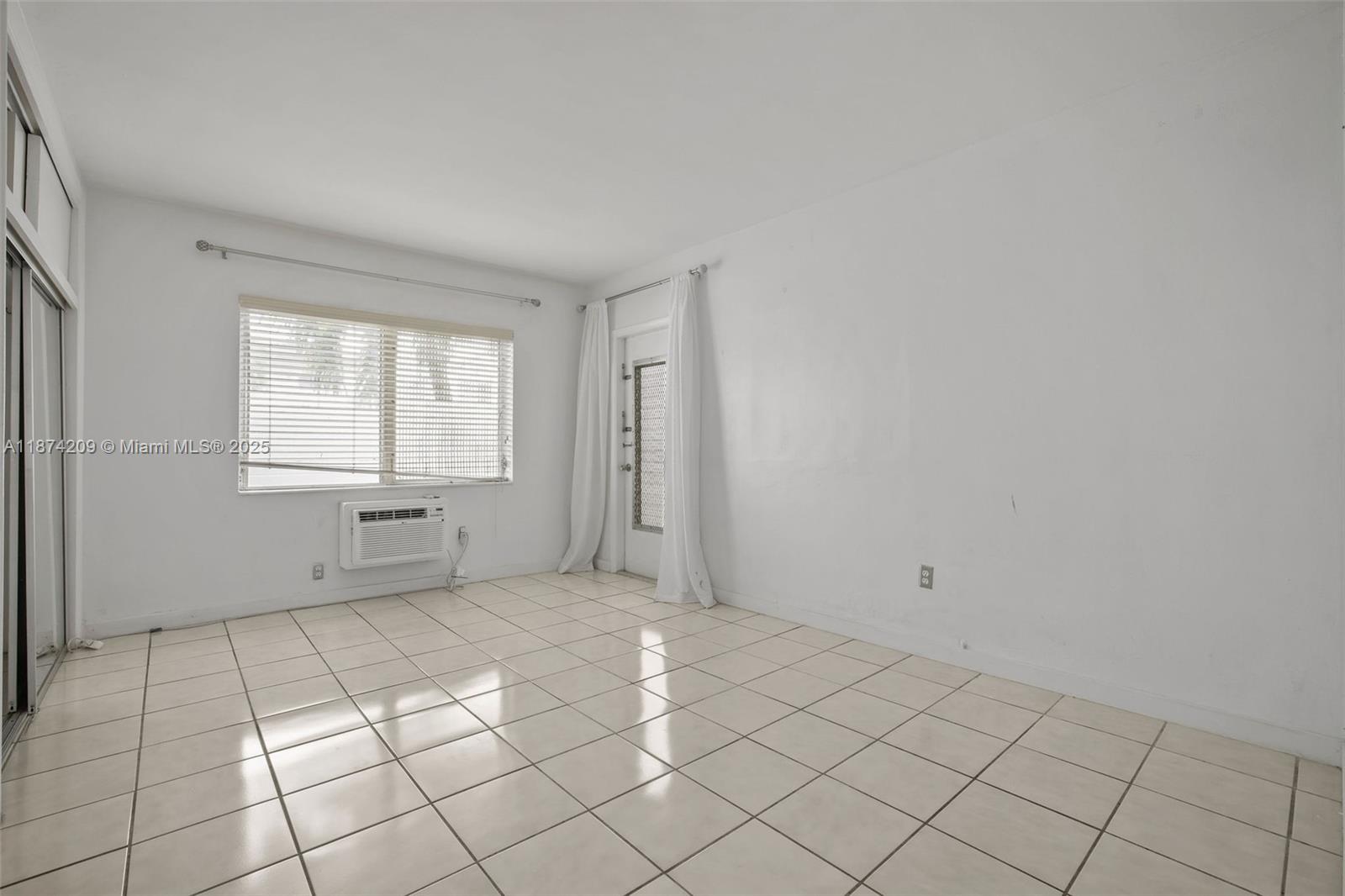 641 Española Way, Unit 3 Miami Beach, FL 33139 - Photo 19 of 23 a view of an empty room with window and cabinet area