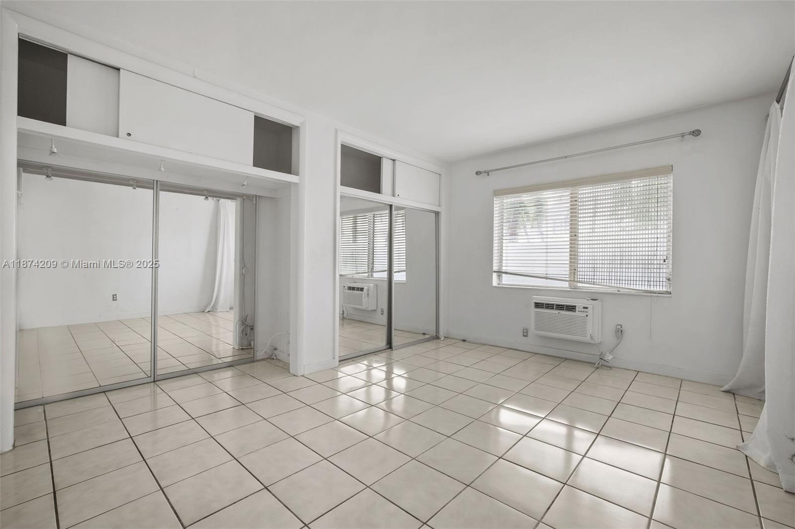 641 Española Way, Unit 3 Miami Beach, FL 33139 - Photo 20 of 23 a view of an empty room with window and cabinet area