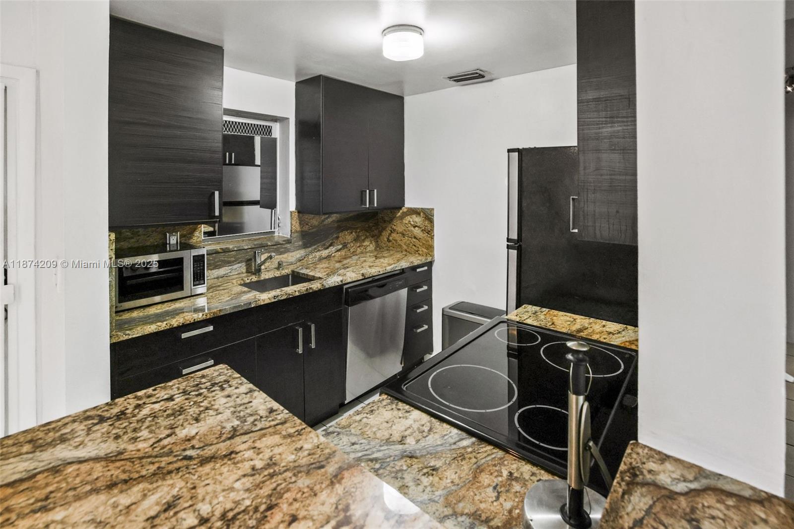 641 Española Way, Unit 3 Miami Beach, FL 33139 - Photo 8 of 23 a kitchen with a stove and a refrigerator