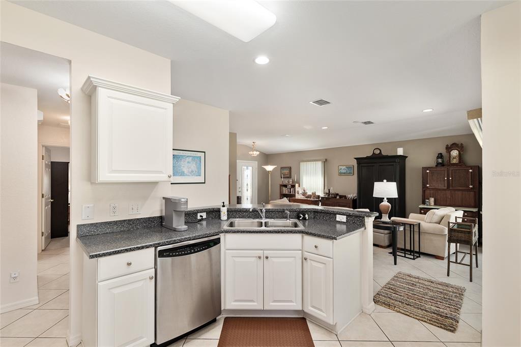 9063 Southeast 120th Loop Summerfield, FL 34491 - Photo 23 of 90 a kitchen with stainless steel appliances granite countertop a stove and cabinets