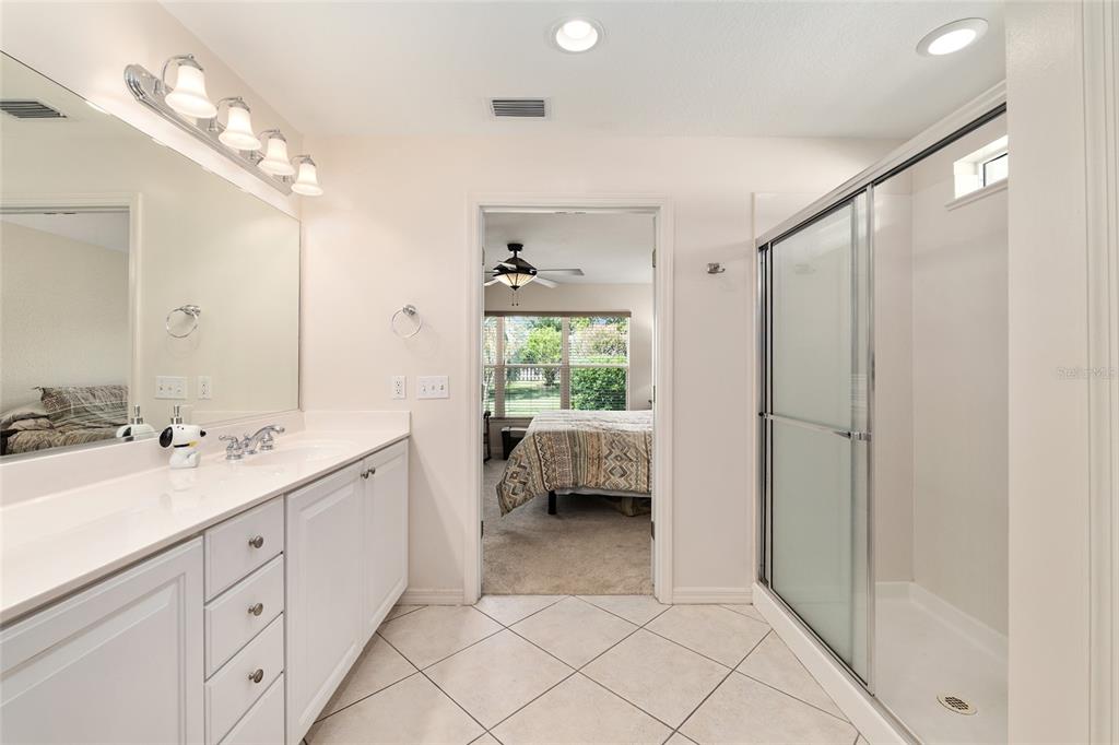 9063 Southeast 120th Loop Summerfield, FL 34491 - Photo 35 of 90 a en suite bathroom with a double vanity sink and a mirror