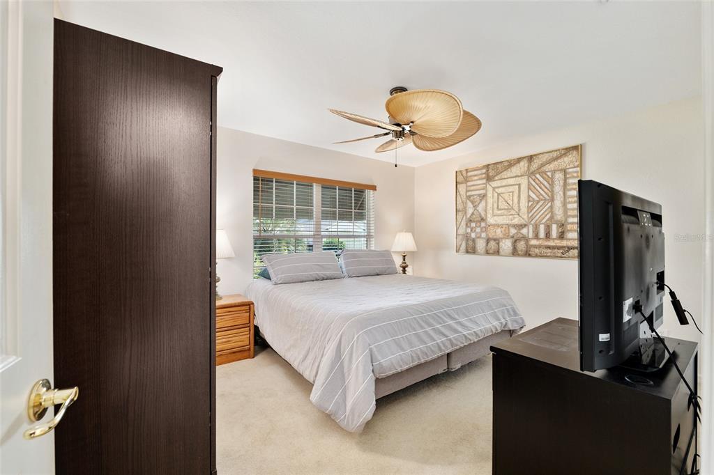 9063 Southeast 120th Loop Summerfield, FL 34491 - Photo 37 of 90 a bedroom with a bed and a chandelier