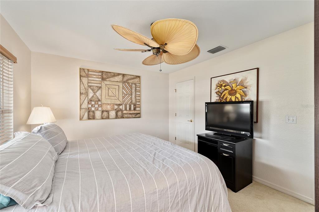 9063 Southeast 120th Loop Summerfield, FL 34491 - Photo 39 of 90 a bedroom with a bed and a flat screen tv