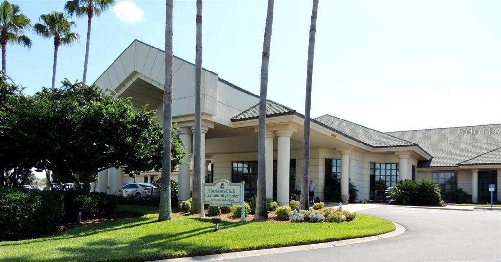 9063 Southeast 120th Loop Summerfield, FL 34491 - Photo 70 of 90 a view of a white house with a small yard and plants