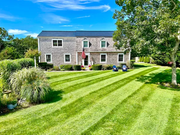 a view of a house with a yard and plants