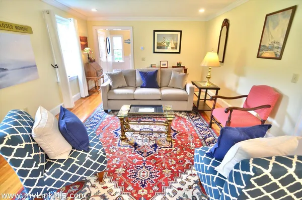 a living room with furniture rug and window