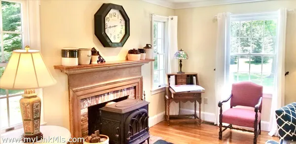 a kitchen with stainless steel appliances granite countertop a refrigerator a stove and a wooden floors