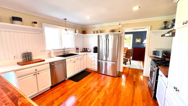 a hallway with furniture and wooden floor