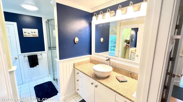 a living room with a baby crib furniture and a wooden floor