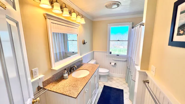 a view of a patio with a table and chairs under an umbrella