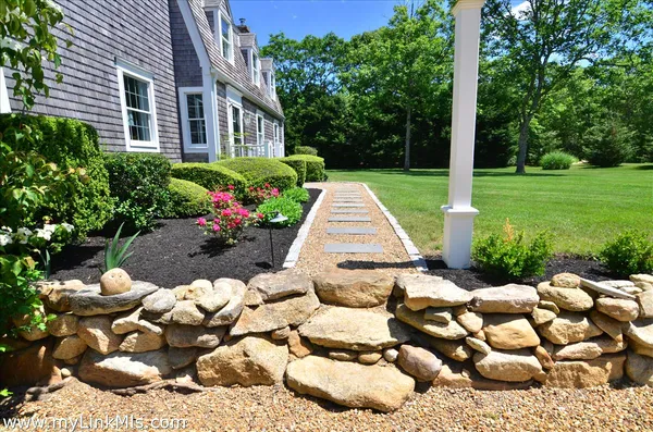 a view of a house with a flower garden