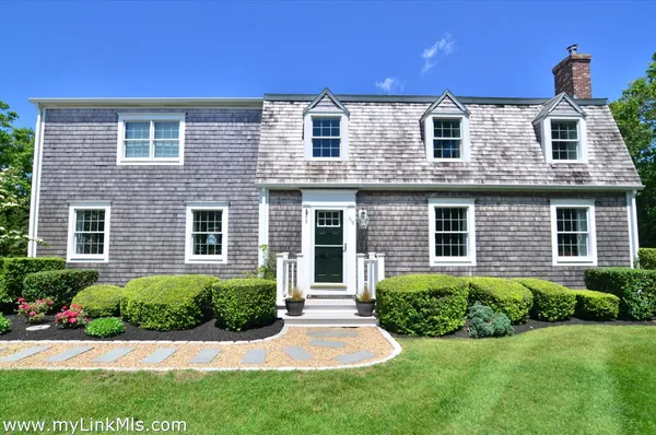 a front view of house with yard and green space