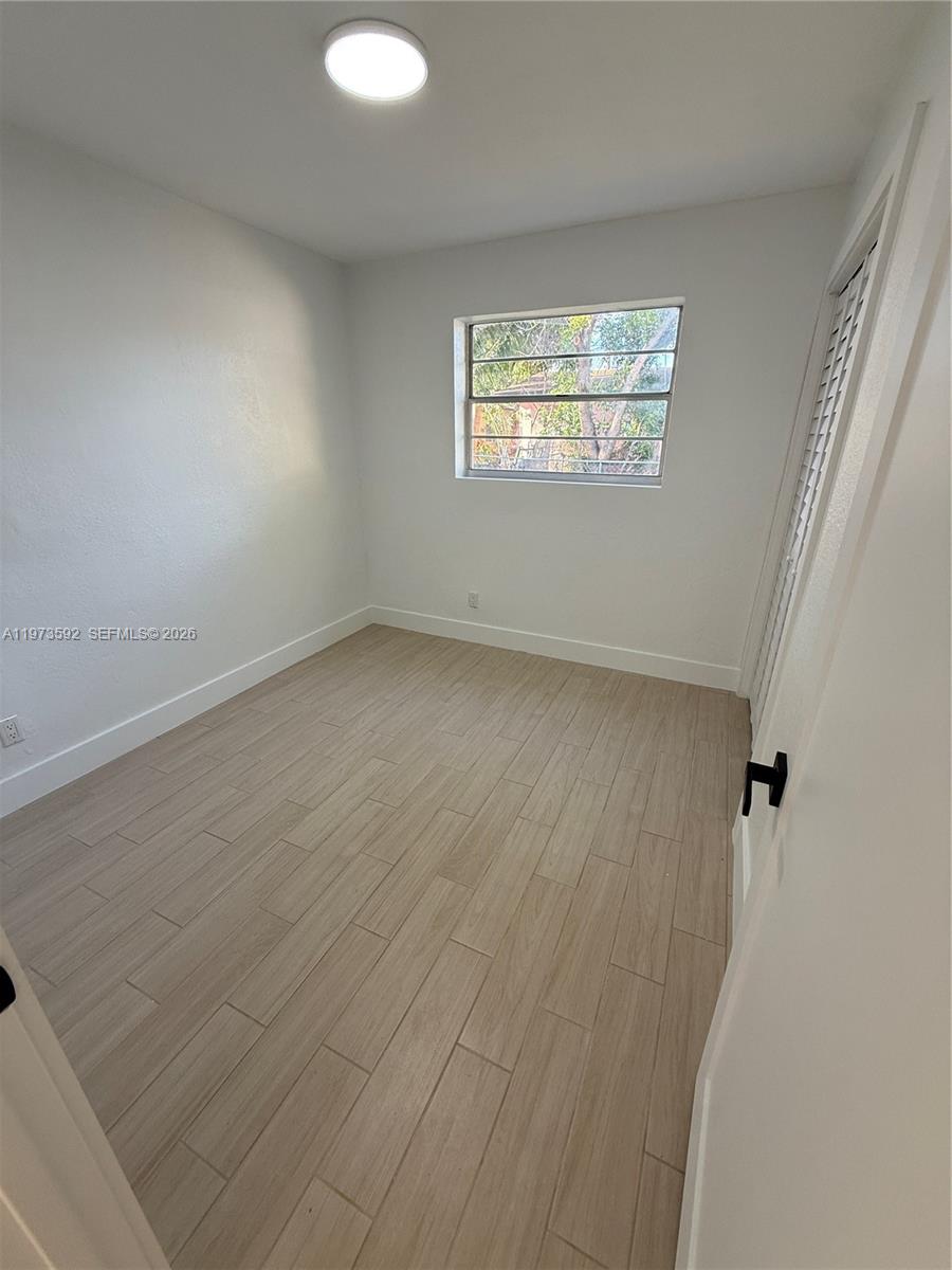 11063 Southwest 5th Street, Unit 11063 Sweetwater, FL 33174 - Photo 11 of 19 an empty room with windows