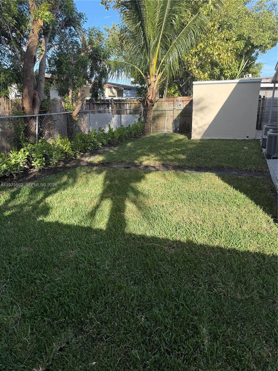 11063 Southwest 5th Street, Unit 11063 Sweetwater, FL 33174 - Photo 16 of 19 a view of a back yard of a house
