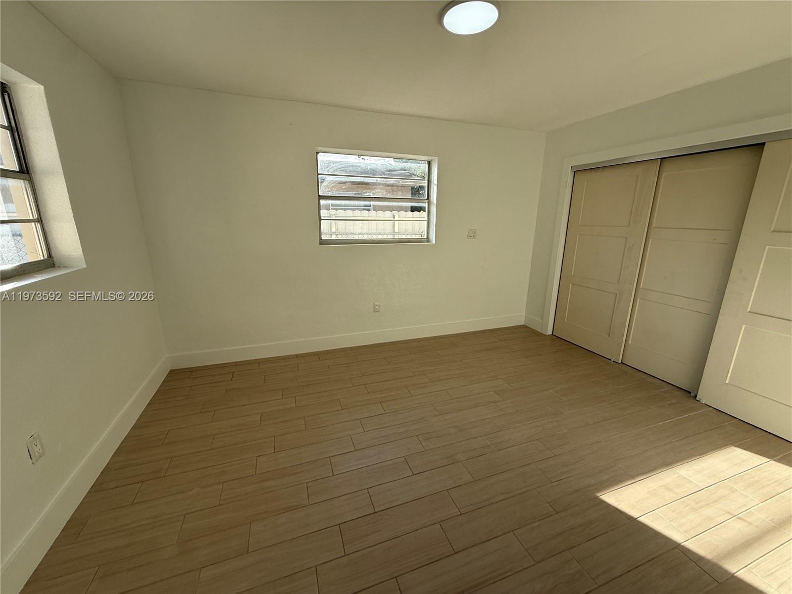 11063 Southwest 5th Street, Unit 11063 Sweetwater, FL 33174 - Photo 7 of 19 an empty room with windows