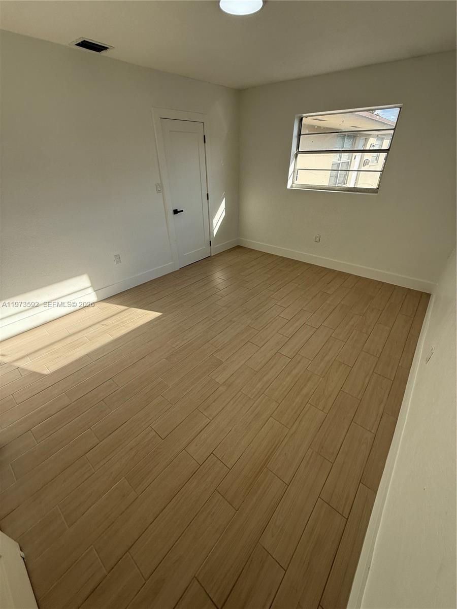 11063 Southwest 5th Street, Unit 11063 Sweetwater, FL 33174 - Photo 8 of 19 a view of empty room with window
