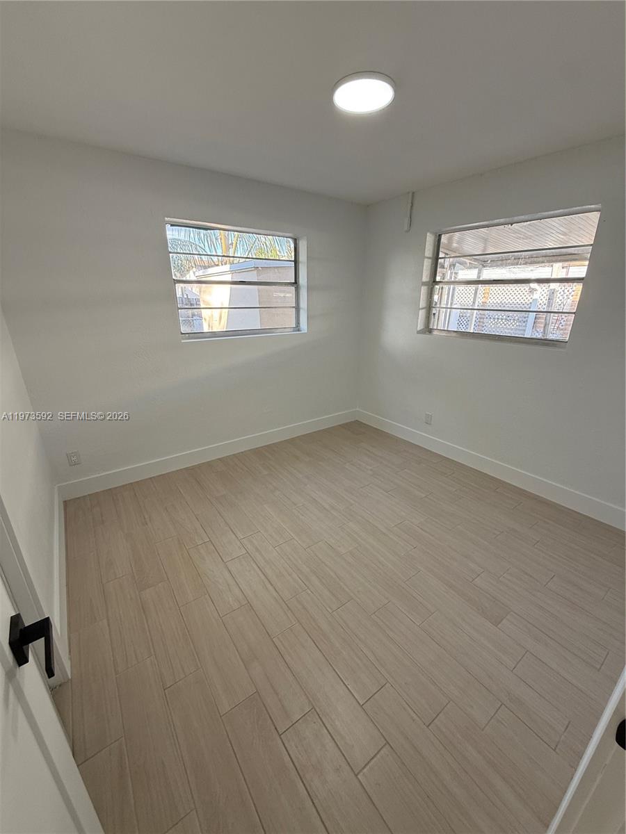 11063 Southwest 5th Street, Unit 11063 Sweetwater, FL 33174 - Photo 9 of 19 a view of an empty room with a window