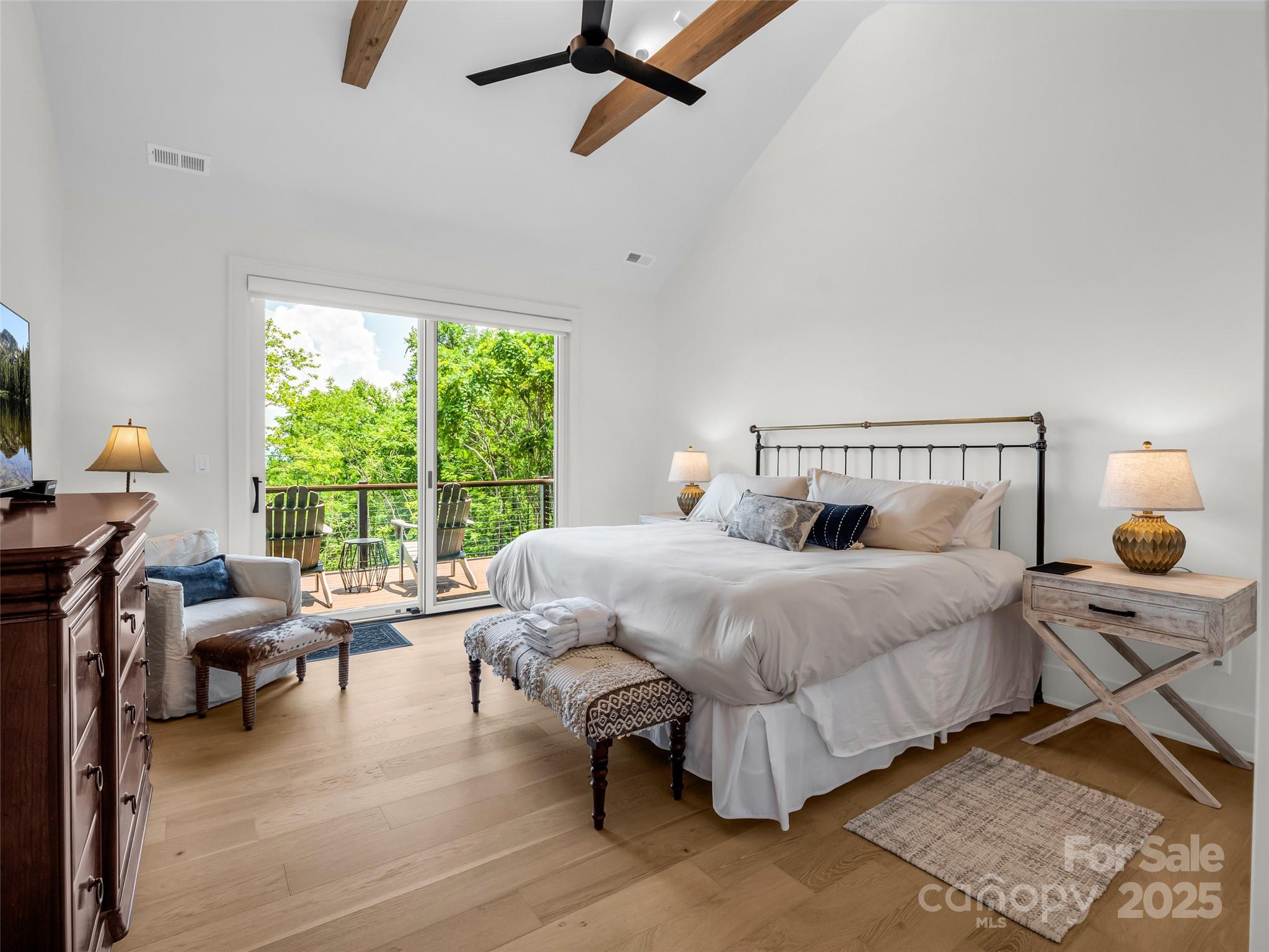 627 Cherry Hill, Unit 201 Mill Spring, NC 28756 - Photo 15 of 48 a bedroom with a bed and large windows