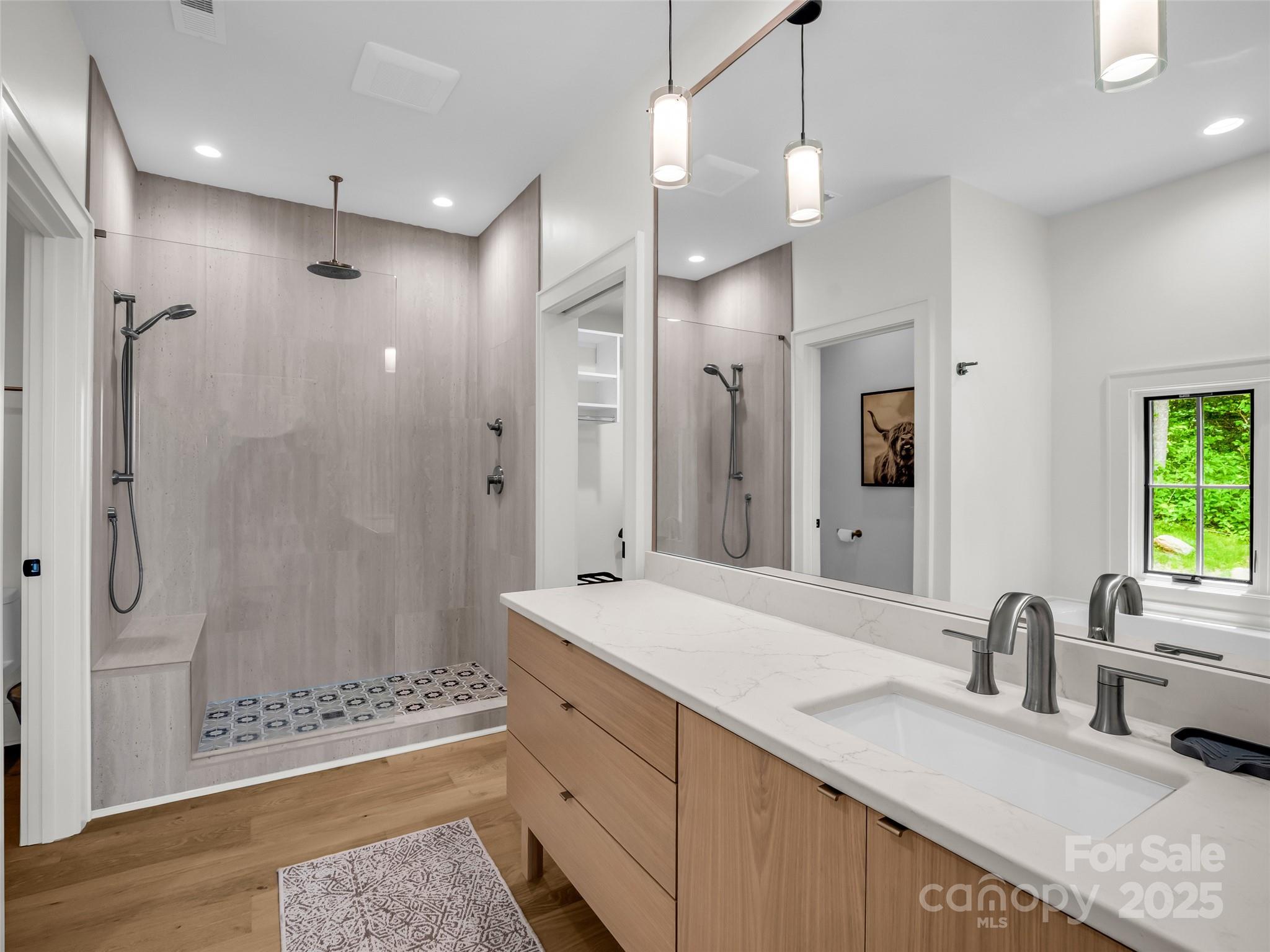 627 Cherry Hill, Unit 201 Mill Spring, NC 28756 - Photo 17 of 48 a bathroom with double vanity sinks and a shower
