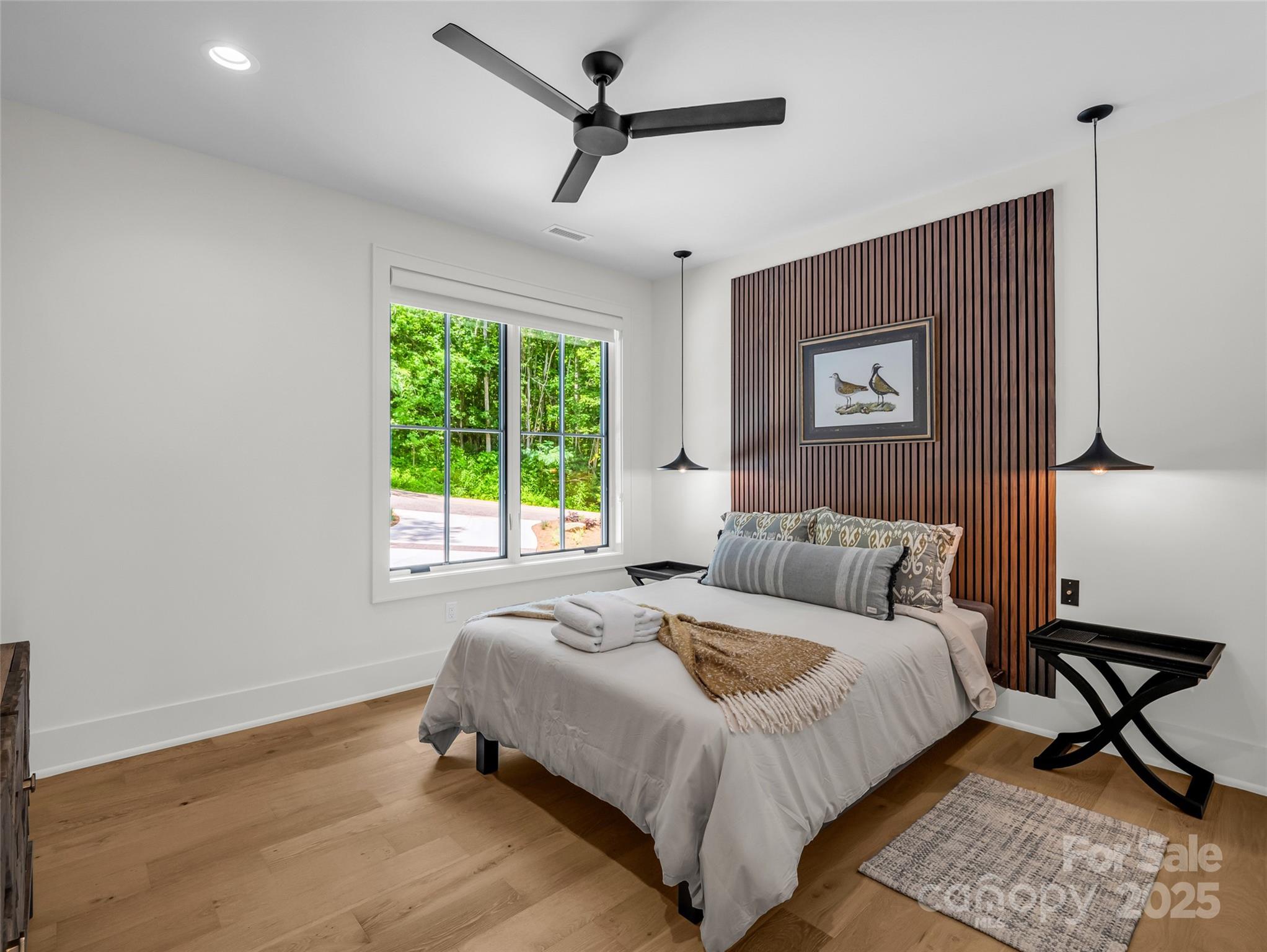 627 Cherry Hill, Unit 201 Mill Spring, NC 28756 - Photo 21 of 48 a bed sitting in a bedroom next to a window