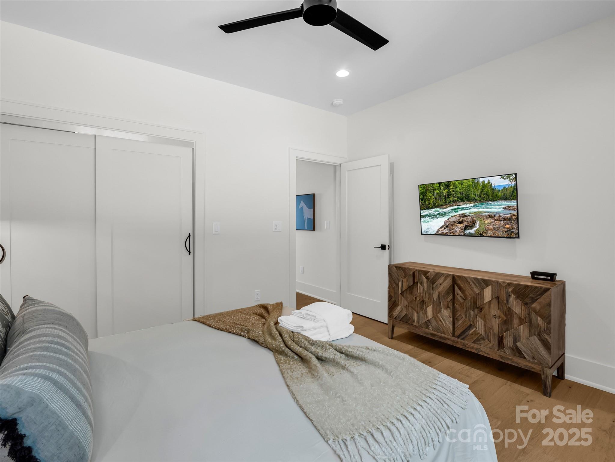 627 Cherry Hill, Unit 201 Mill Spring, NC 28756 - Photo 22 of 48 a bedroom with a bed and a couch