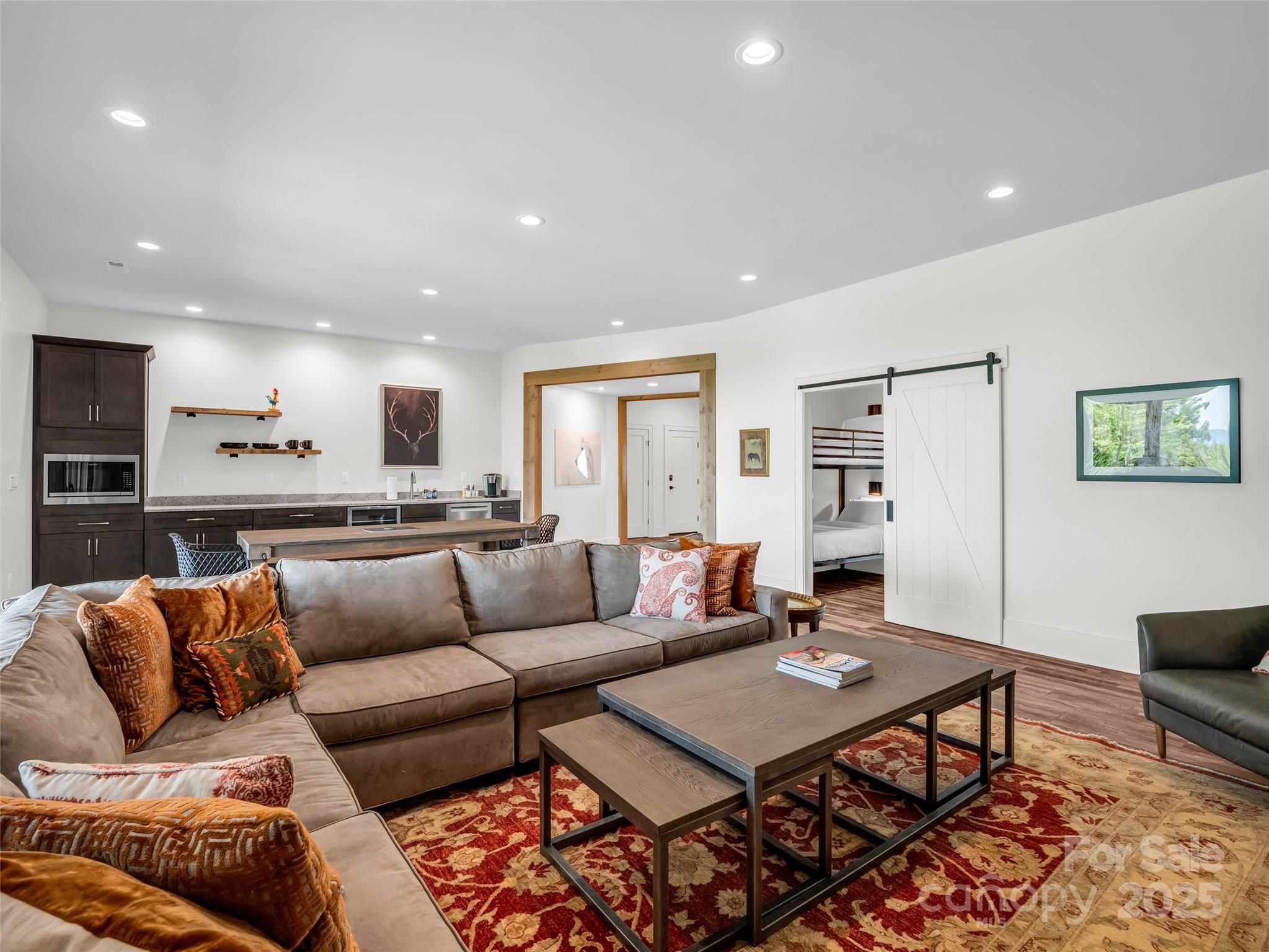 627 Cherry Hill, Unit 201 Mill Spring, NC 28756 - Photo 28 of 48 a living room with a couch and kitchen view