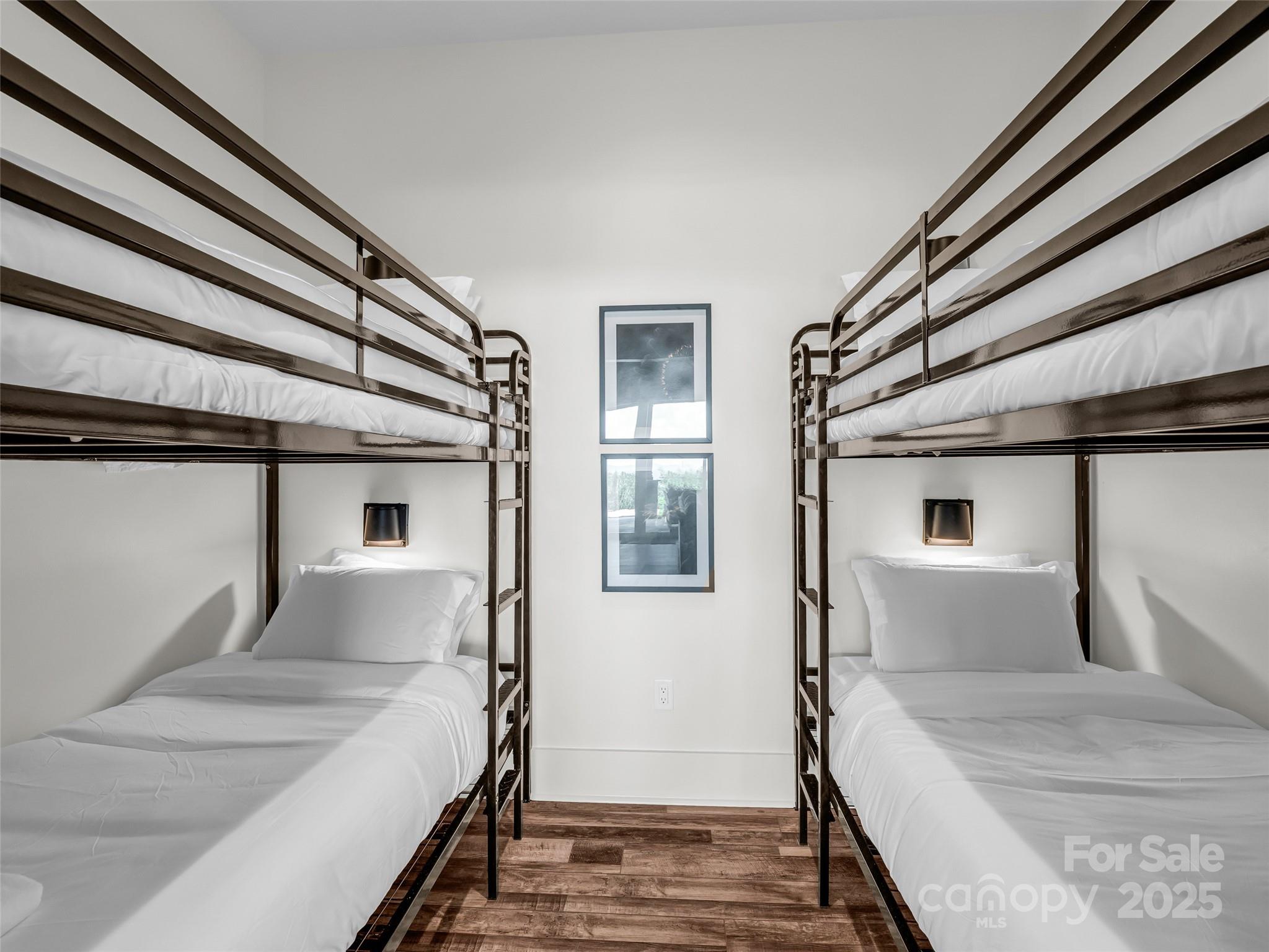 627 Cherry Hill, Unit 201 Mill Spring, NC 28756 - Photo 29 of 48 a bedroom with a bed and wooden floor