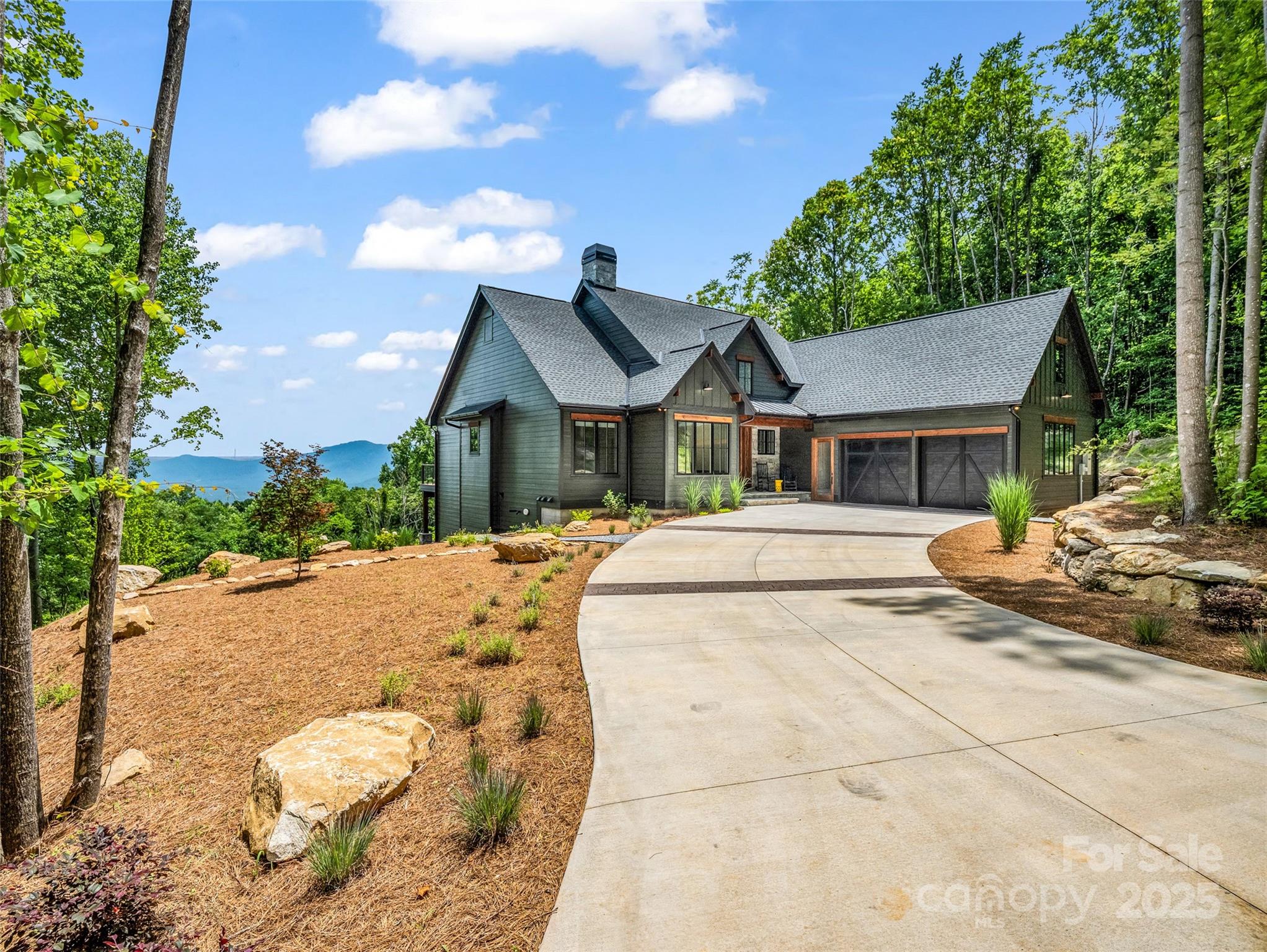 627 Cherry Hill, Unit 201 Mill Spring, NC 28756 - Photo 3 of 48 a view of a white house with a yard and large tree