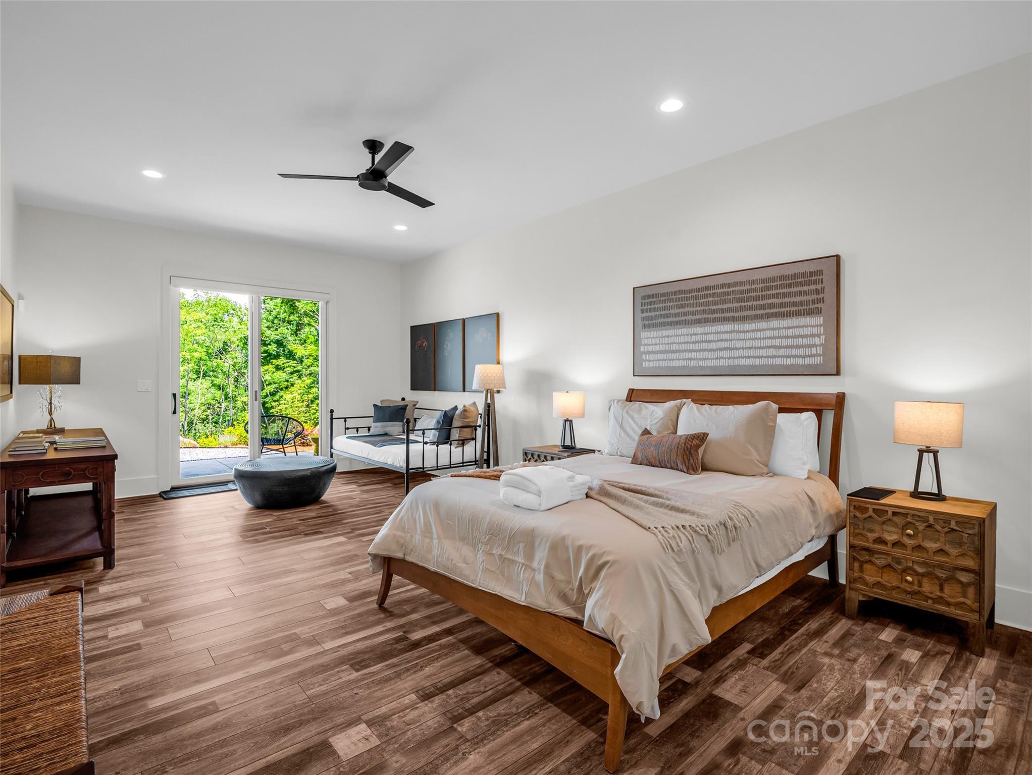 627 Cherry Hill, Unit 201 Mill Spring, NC 28756 - Photo 31 of 48 a bedroom with a bed a large window and wooden floor